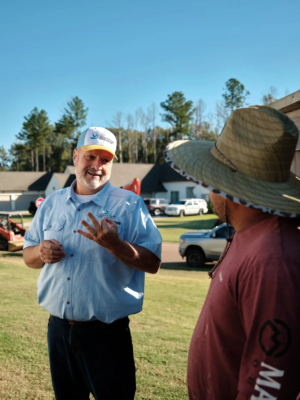 Team member explaining a pool project to a customer on site